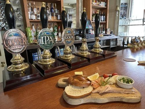 a bar with a plate of food on a counter at Lord Nelson Hotel in Bridport