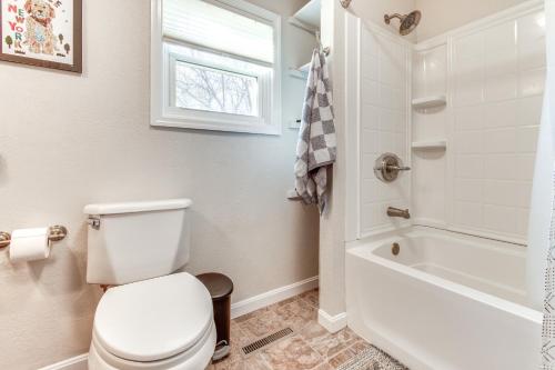 a bathroom with a toilet and a tub and a window at Hike, Boat and Fish Dog-Friendly Robinson Home in Robinson