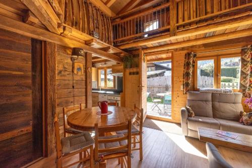 - une salle à manger et une cuisine dans une cabane en rondins dans l'établissement Les Chalets du Bonheur, aux Houches