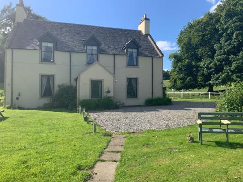 a large white house with benches in front of it at Antfield house in Inverness