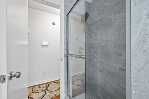a shower with a glass door in a bathroom at Spacious Alpharetta 3bedroom Home in Alpharetta