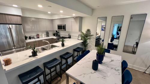 a kitchen with two tables and chairs and a counter at Century City Cozy 3 Bedroom Apartment with Parking 302,303 in Los Angeles