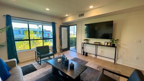 a living room with a large flat screen tv at Century City Cozy 3 Bedroom Apartment with Parking 302,303 in Los Angeles