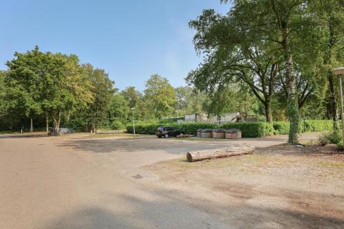 a car parked in a parking lot with a log at Landgoed Leudal in Haelen