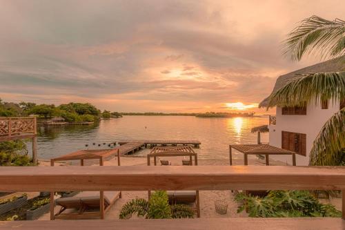a view of a body of water with tables and chairs at Islawa Soy Local - Isla Privada in Baru
