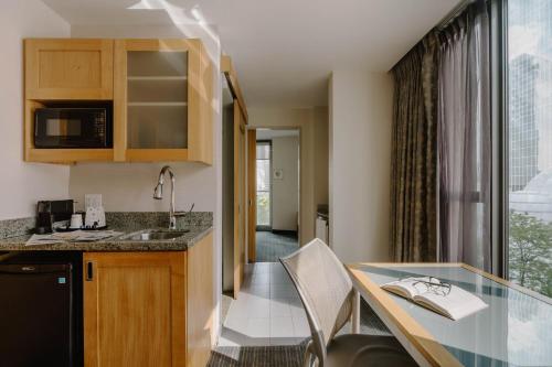 a kitchen with a counter top and a table at Club Quarters Hotel World Trade Center, New York in New York