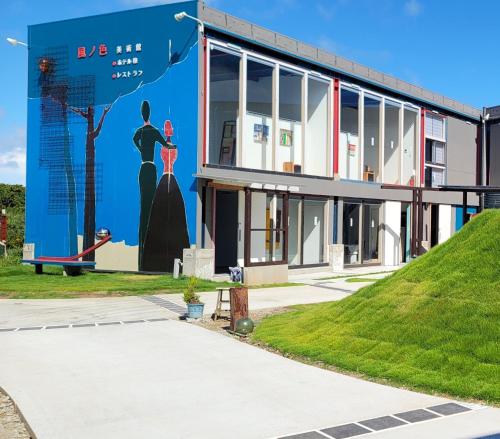 a building with a mural on the side of it at Kaze no iro Bijutsukan - Vacation STAY 29975v in Asahi