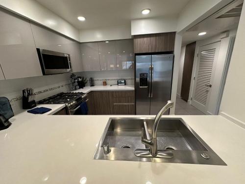 a kitchen with a stainless steel sink in a kitchen at Century City Cozy 3 Bedroom Apartment with Parking 302,303 in Los Angeles
