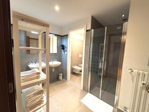 a bathroom with a shower and a toilet and a sink at Victoria Royal Garden in Como