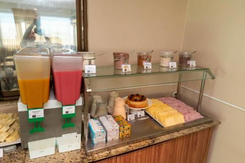 a display case with some drinks and other food at Rede Andrade Riviera Premium in Salvador