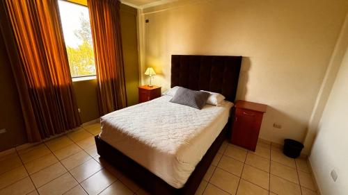 a bedroom with a bed and a window at Hotel de Santa Maria in Santa Cruz del Quiché