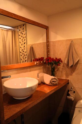 a bathroom with a sink and a mirror at Casa Jazmín Hospedaje Familiar Eco Amigable - Huayoccari, Sacred Valley in Huayoccare