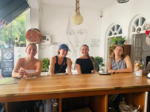 a group of women sitting at a wooden table at le bella1912 in Galle