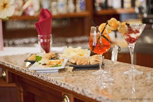 a table with plates of food and glasses of wine at Grand Hotel & des Anglais Spa in Sanremo