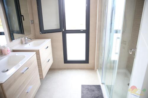 a bathroom with a sink and a glass shower at Villa Blanca with private pool - San Javier in San Javier