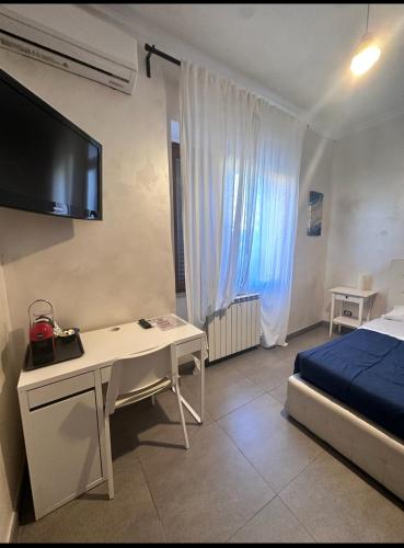 a bedroom with a desk and a bed and a tv at Sabrina Airport in Fiumicino