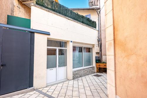 a building with white doors and windows on it at Il Était Une Fois - GAP Chambre romantique & SPA in Gap