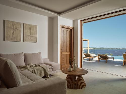 a living room with a couch and a table at Thesan Villas in Marathias