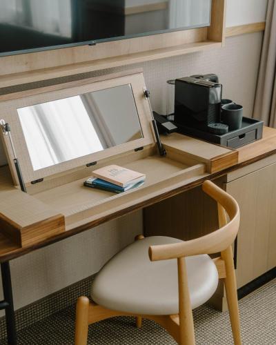 a desk with a mirror and a chair in a room at Club Quarters Hotel St Paul's, London in London