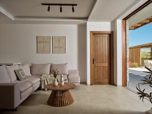 a living room with a couch and a table at Thesan Villas in Marathias