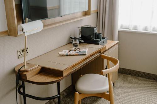 a room with a desk with a computer and a chair at Club Quarters Hotel St Paul's, London in London