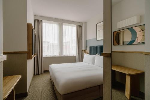 a hotel room with a bed and a window at Club Quarters Hotel St Paul's, London in London