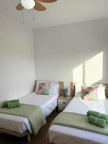 a bedroom with two beds and a ceiling at El Paraiso in Gran Tarajal