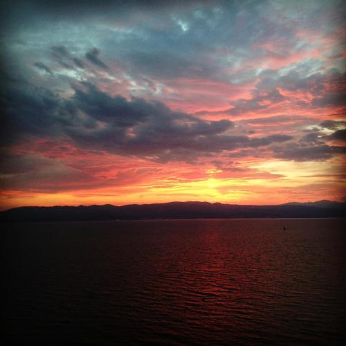 a sunset over a large body of water at Fener Hotel Café & Kahvalti in Cesme