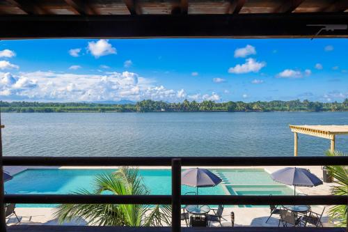 a view of a lake from a balcony at Riverside Hotel Chachalacas in Chachalacas