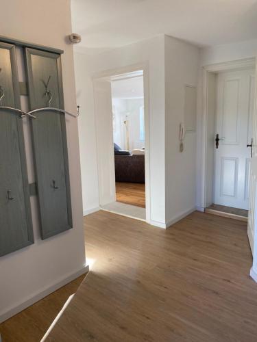 an empty living room with a door and a hallway at Eisern Home 2 in Mittenwalde
