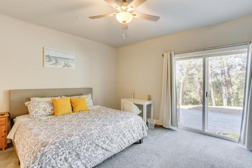 a bedroom with a bed and a ceiling fan at 5 Mi to Shasta Lake Newly Built Home with Backyard! in Shasta Lake