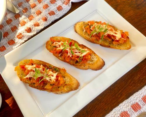 three small pizzas on a white plate on a table at Casa Park in Paraty