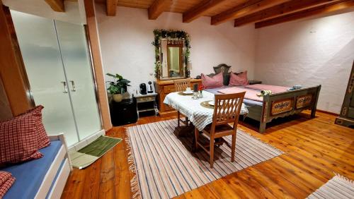 a living room with a table and a couch at Sonnleit'n Zimmer 7 in Abtenau