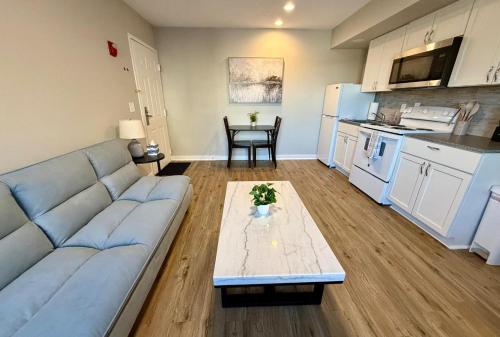 a living room with a couch and a table at Aksarben View One Bedroom in Omaha