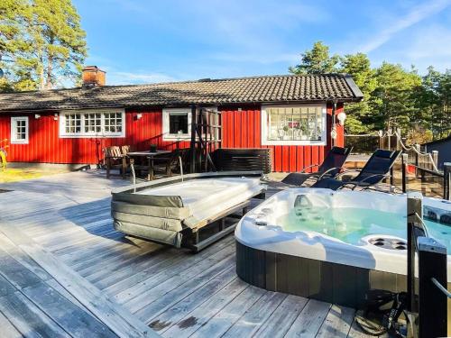 a hot tub on a deck next to a house at 7 person holiday home in Mönsterås in Mönsterås