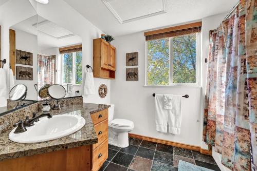 a bathroom with a sink and a toilet and a window at Eden Escape most desirable floor plans in all of Moose Hollow Luxury Condos in Eden