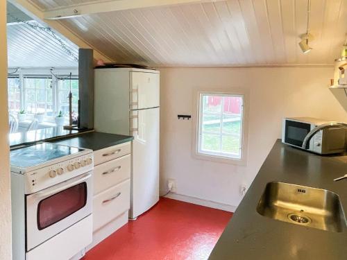 a kitchen with a white refrigerator and a sink at 7 person holiday home in Mönsterås in Mönsterås