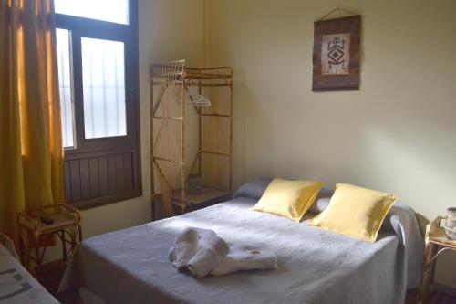 a bedroom with a bed with a towel on it at Apart Hotel Ñusta in Cafayate