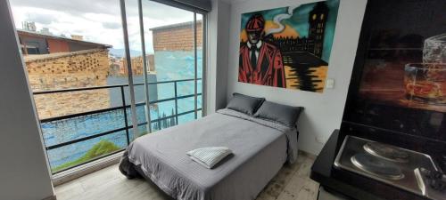 a bedroom with a bed and a large window at Las Aguas Inner Experience in Bogotá
