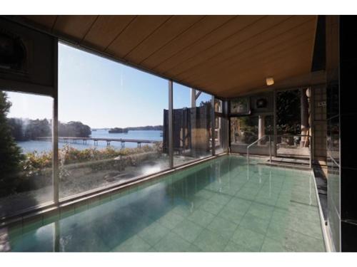 a house with a swimming pool with a view of the water at Hotel Zekkei no Yakata - Vacation STAY 47604v in Takagi