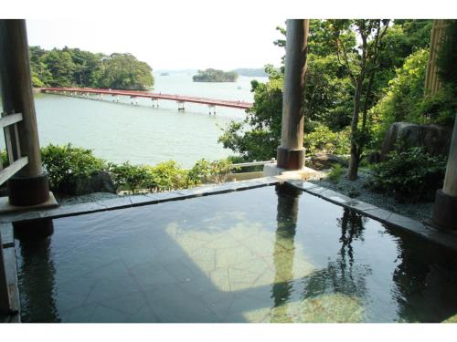a swimming pool with a view of a body of water at Hotel Zekkei no Yakata - Vacation STAY 47604v in Takagi