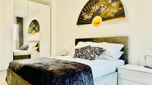 a bedroom with a large bed and a mirror at The Family Home in Rozzano