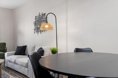 a living room with a table and a couch at Hines Haven - Unit 2 - Perfect BNB for YOU in Peoria