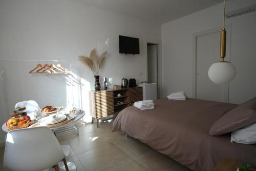 a bedroom with a bed and a table with fruit on it at B&B CasaLù in Sammichele di Bari