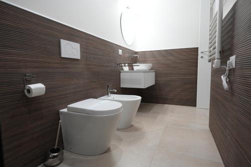 a bathroom with a toilet and a sink at B&B CasaLù in Sammichele di Bari