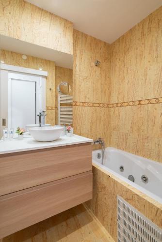 a bathroom with a sink and a tub at Host Wise - Stunning Trendy Flat w Balcony - Matosinhos in Matosinhos