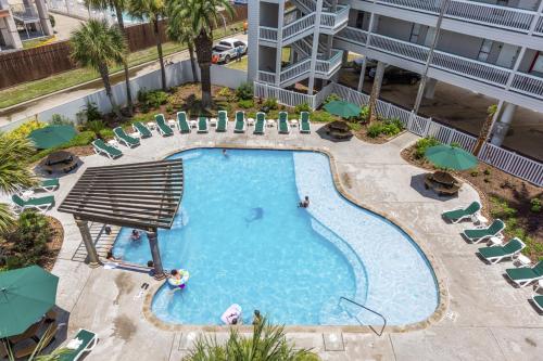 an overhead view of a swimming pool at a hotel at Oceanfront Condo Heated Pool Walk to Beach Views in Galveston