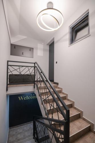 a staircase with a large light fixture in a building at UpArt Home & Spa in Ðakovo
