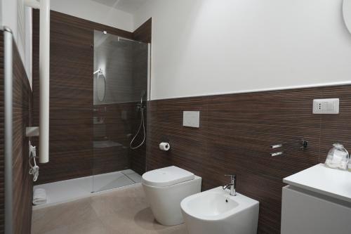 a bathroom with a toilet and a sink and a shower at B&B CasaLù in Sammichele di Bari