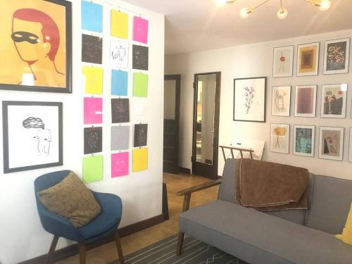 a living room with a couch and a chair at Gallery Loft of Oak Park #1 Top Host in IL in Oak Park